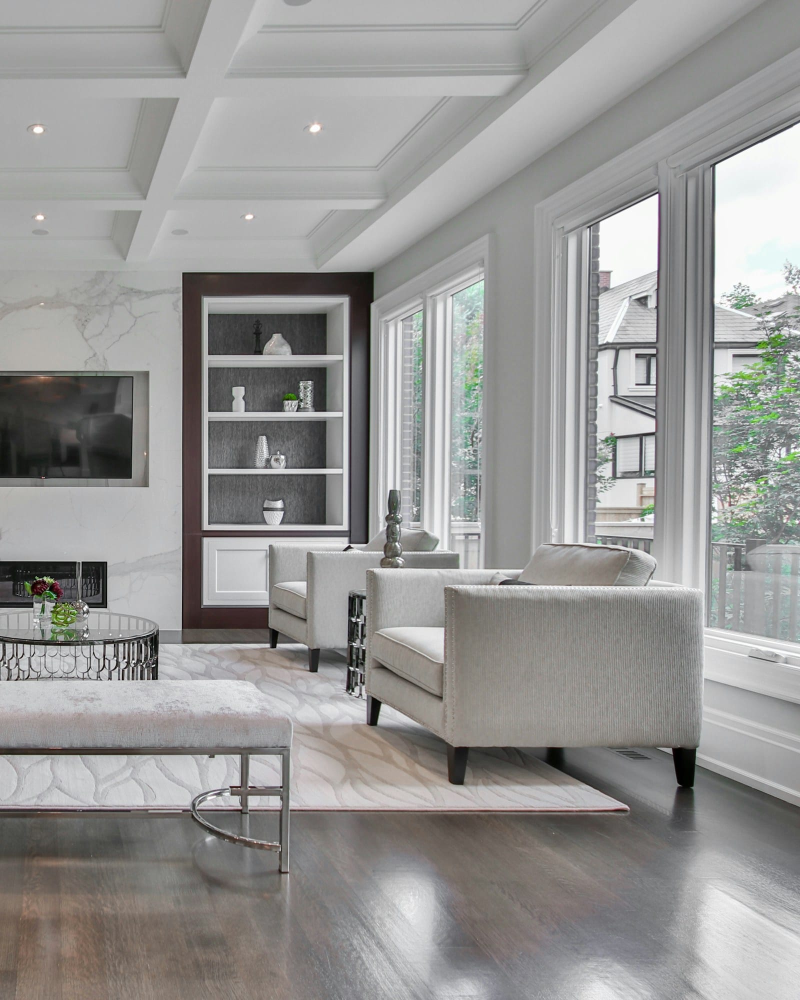 The living room in soft green, opening to the kitchen beyond
